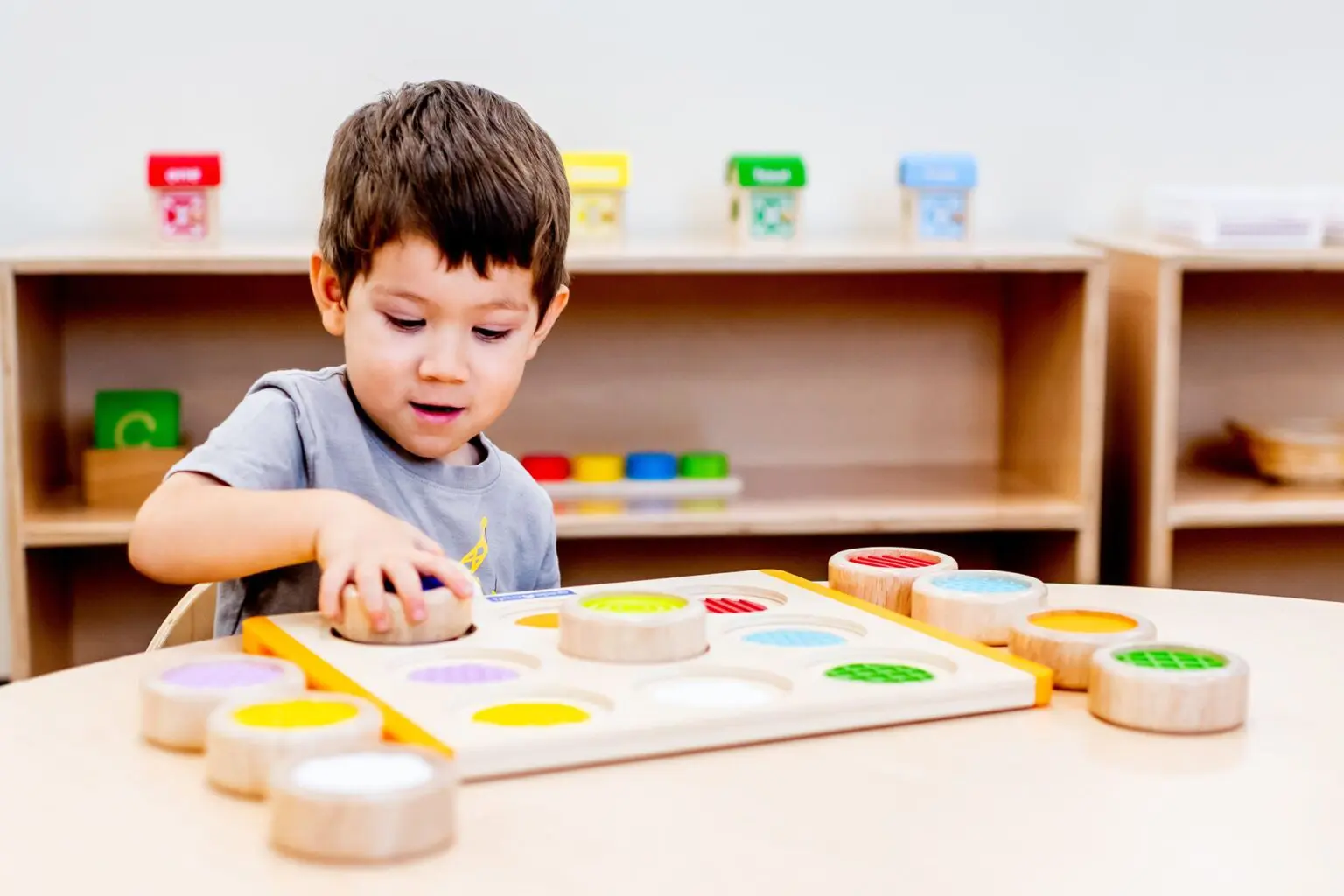 A young boy is playing with his toy.