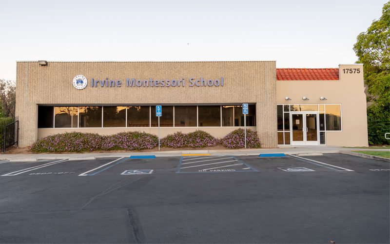 A large building with a parking lot in front of it.