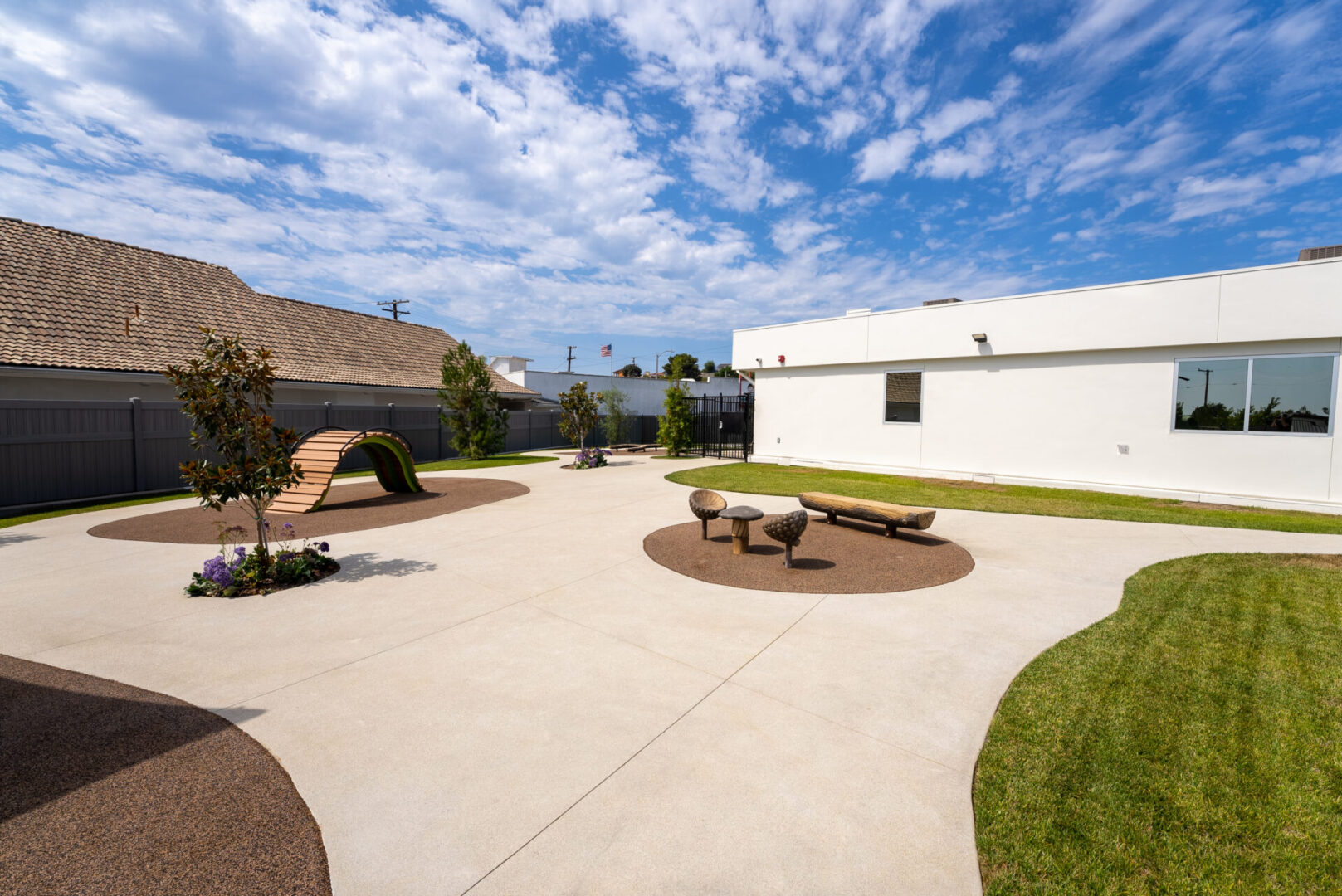 A courtyard with benches and trees in the center.